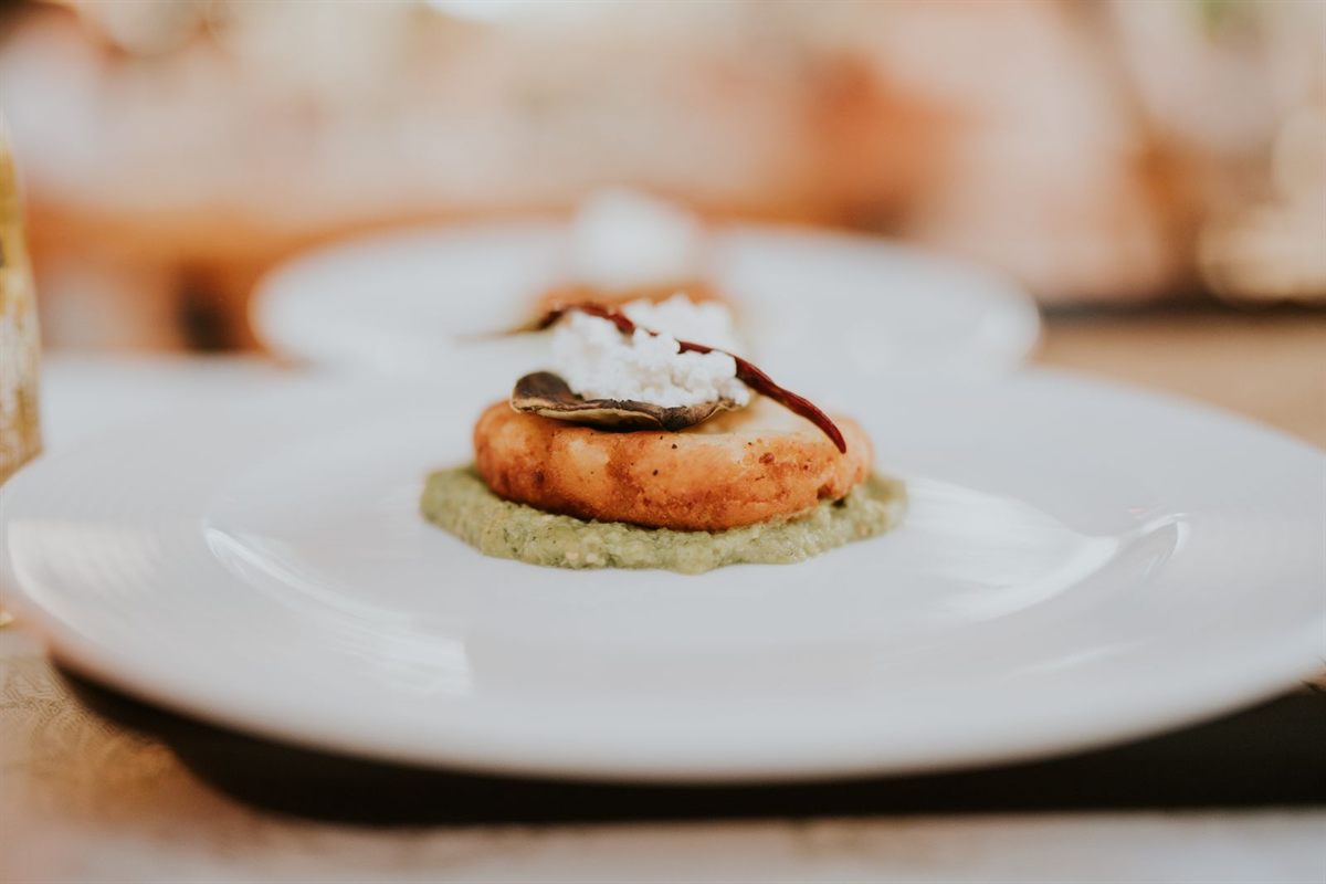 A small appetizer served on a white plate in a restaurant