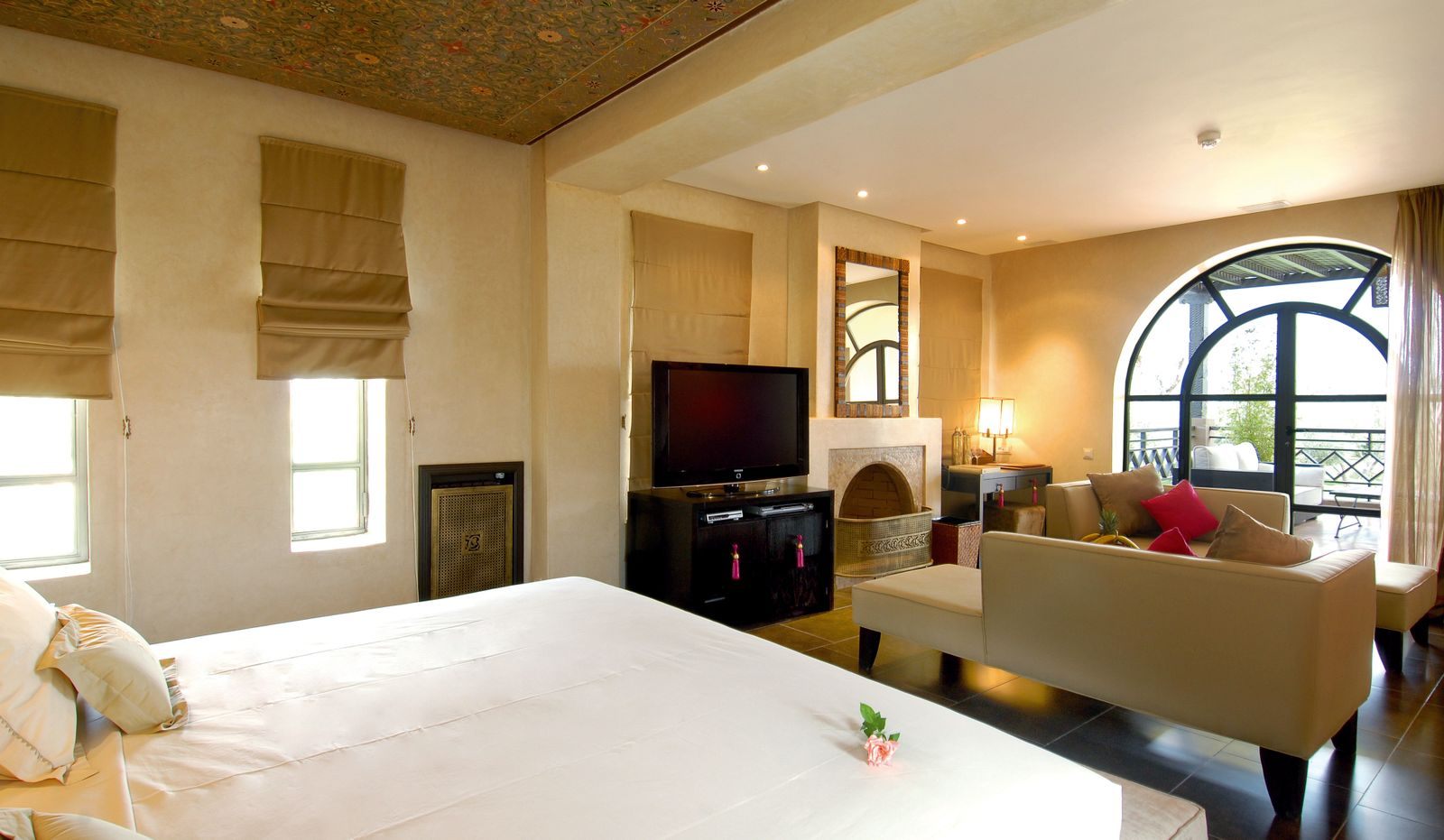 A bright suite with a large bed and sitting area, ready for all inclusive cruises 2027 bookings